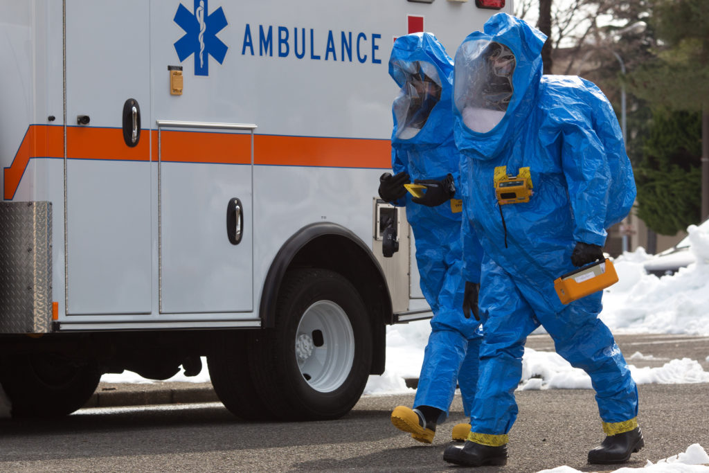 (Right to left) Staff Sgt. Wesley Barlow, 374th Aerospace Medicine Squadron bioenvironmental engineering technician, and Airman 1st Class Marissa Kiracofe, 374th Civil Engineer Squadron emergency management technician, respond to a simulated unknown substance during a hazardous material training exercise at Yokota Air Base, Japan, Feb. 20, 2014. The primary purpose of the exercise was joint crime scene preservation training among emergency management, bioenvironmental engineers, fire department, security forces, medical technicians, and Air Force Office of Special Investigations to ensure minimal scene disturbance while completing presumptive identification, sampling and evidence collection. (U.S. Air Force photo by Osakabe Yasuo/Released)